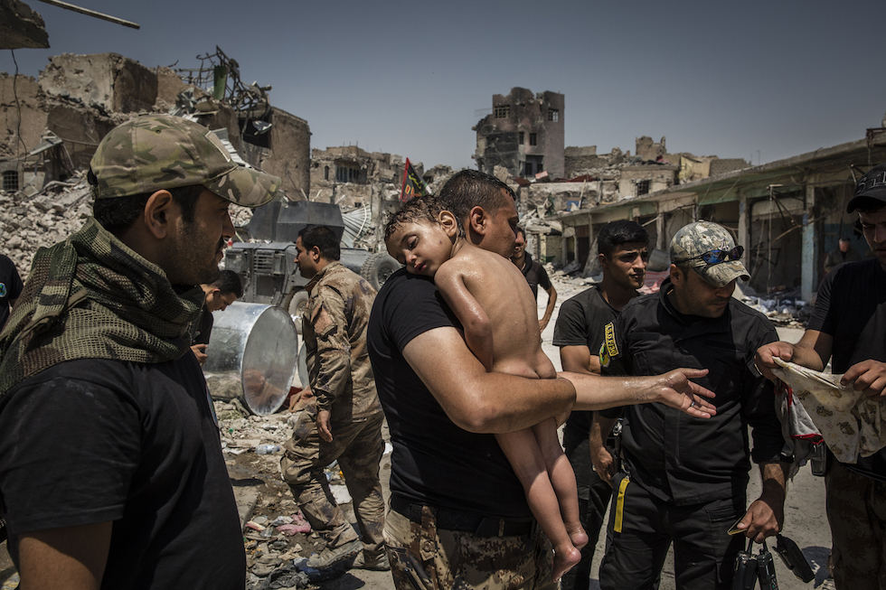 Ivor Prickett, The Battle for Mosul - Young Boy Is Cared for by Iraqi Special Forces Soldiers